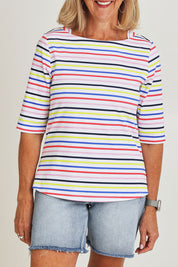 Model Sandy wearing size S of the Even Keel Cotton Top in colour Multistrip (Pink), from the front, cropped image
