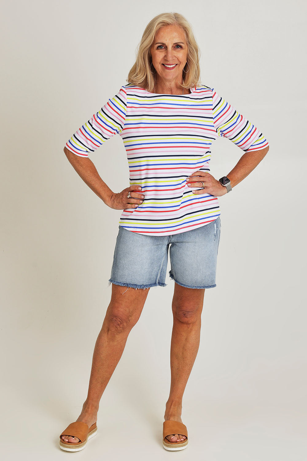 Model Sandy wearing size S of the Even Keel Cotton Top in colour Multistrip (Pink), from the front, showing the whole outfit