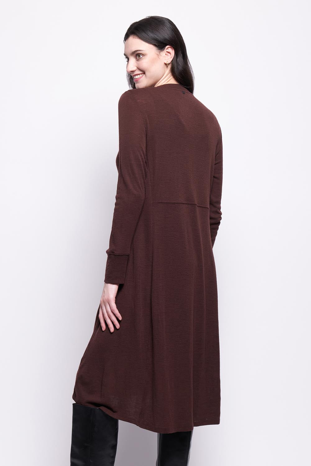 A model wearing the Merino Shear Ecstasy Dress in colour Raisin, from the back