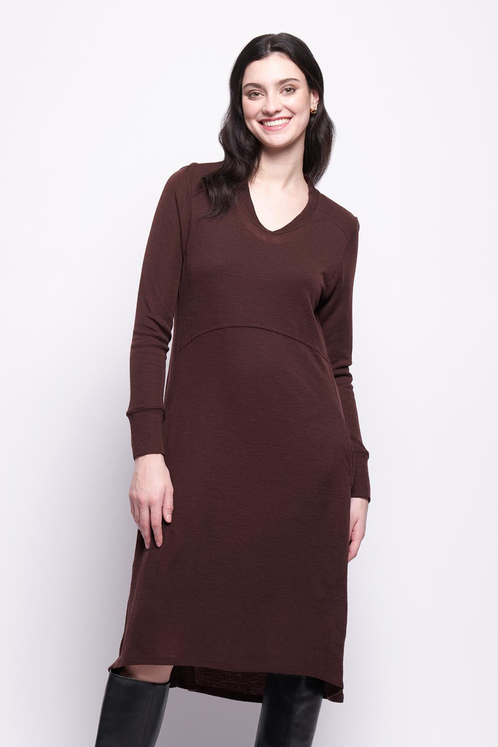 A model wearing the Merino Shear Ecstasy Dress in colour Raisin, from the front, cropped image