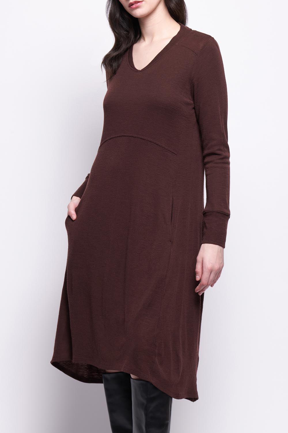 A model wearing the Merino Shear Ecstasy Dress in colour Raisin, from the front, cropped image