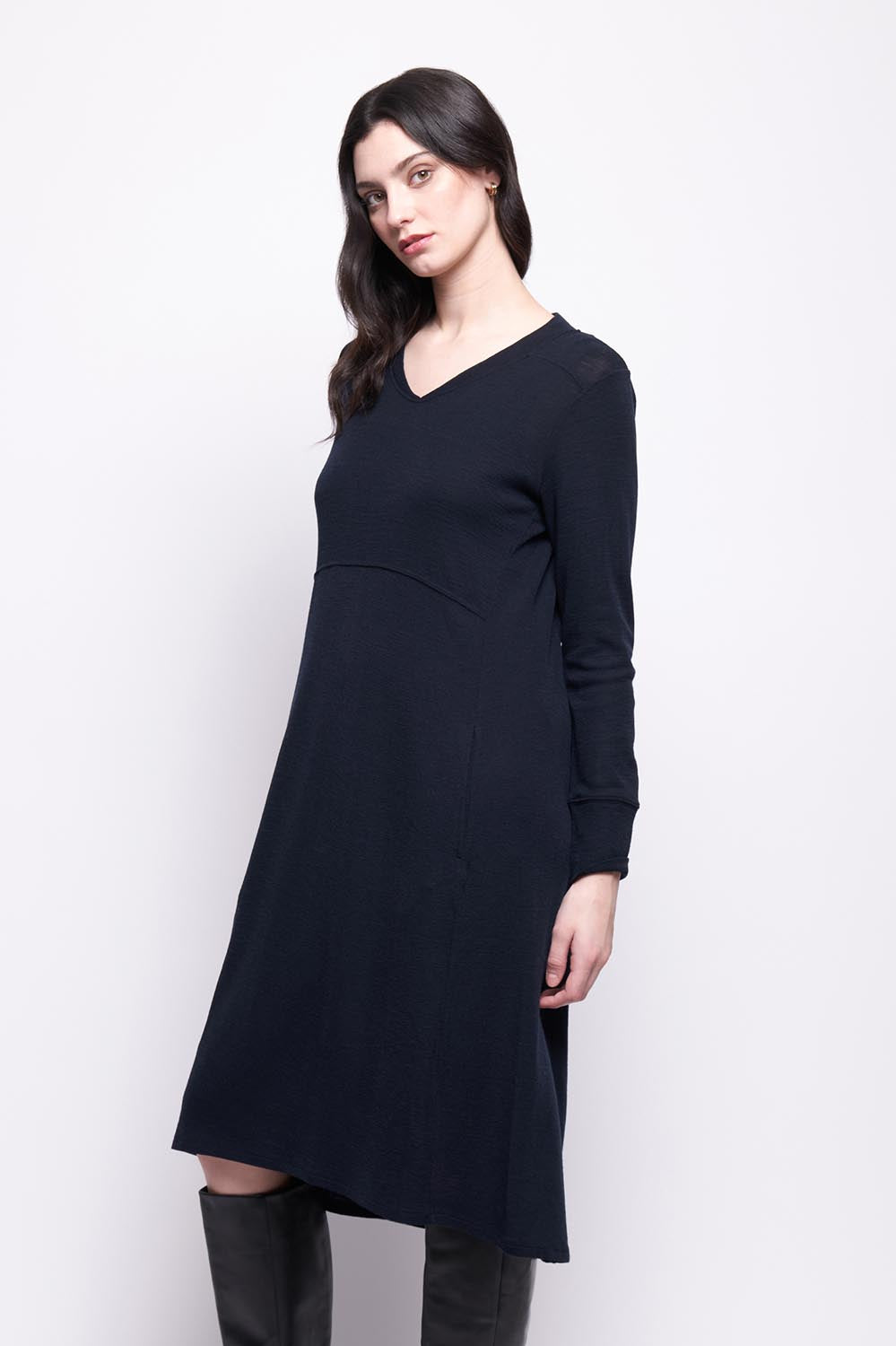 A model wearing the Merino Shear Ecstasy Dress in colour Truenavy (Blue), from the front, cropped image