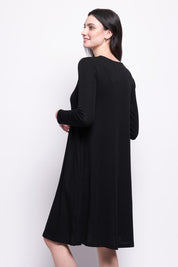 A model wearing the Merino Shear Delight Dress in colour Black (Black), from the back