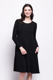 A model wearing the Merino Shear Delight Dress in colour Black (Black), from the front, cropped image
