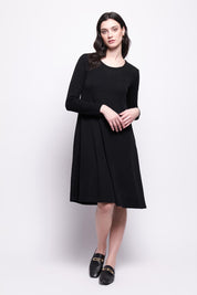 A model wearing the Merino Shear Delight Dress in colour Black (Black), from the front, showing the whole outfit
