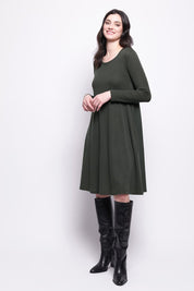 A model wearing the Merino Shear Delight Dress in colour Moss (Green), from the front, showing the whole outfit