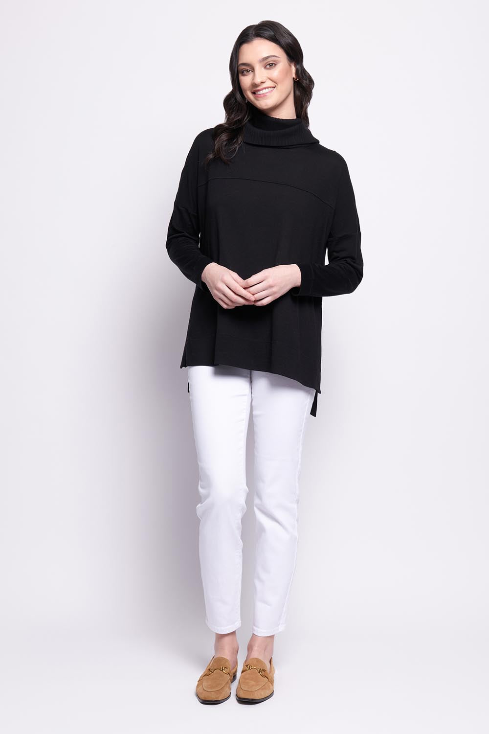 A model wearing the Merino Love Your Moves Sweater in colour Black (Black), from the front, showing the whole outfit