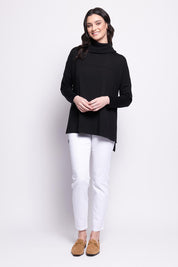 A model wearing the Merino Love Your Moves Sweater in colour Black (Black), from the front, showing the whole outfit