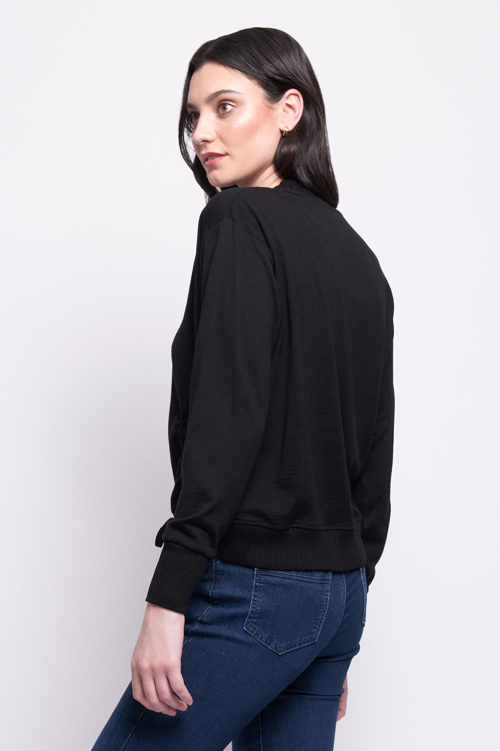 A model wearing the Merino Best Side Top in colour Black (Black), from the back