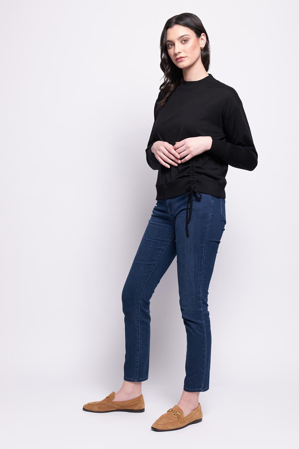 A model wearing the Merino Best Side Top in colour Black (Black), from the front, showing the whole outfit