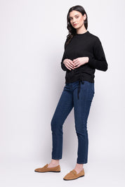 A model wearing the Merino Best Side Top in colour Black (Black), from the front, showing the whole outfit
