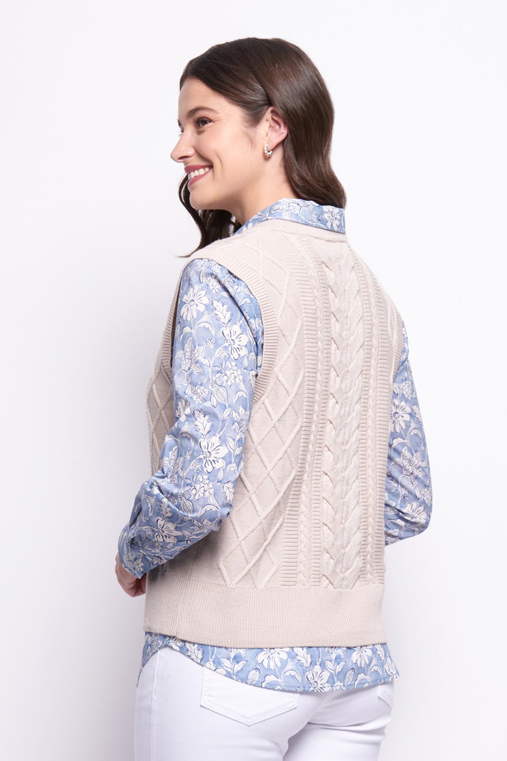 A model wearing the Merino Plot Twist Vest in colour Pearl, from the back