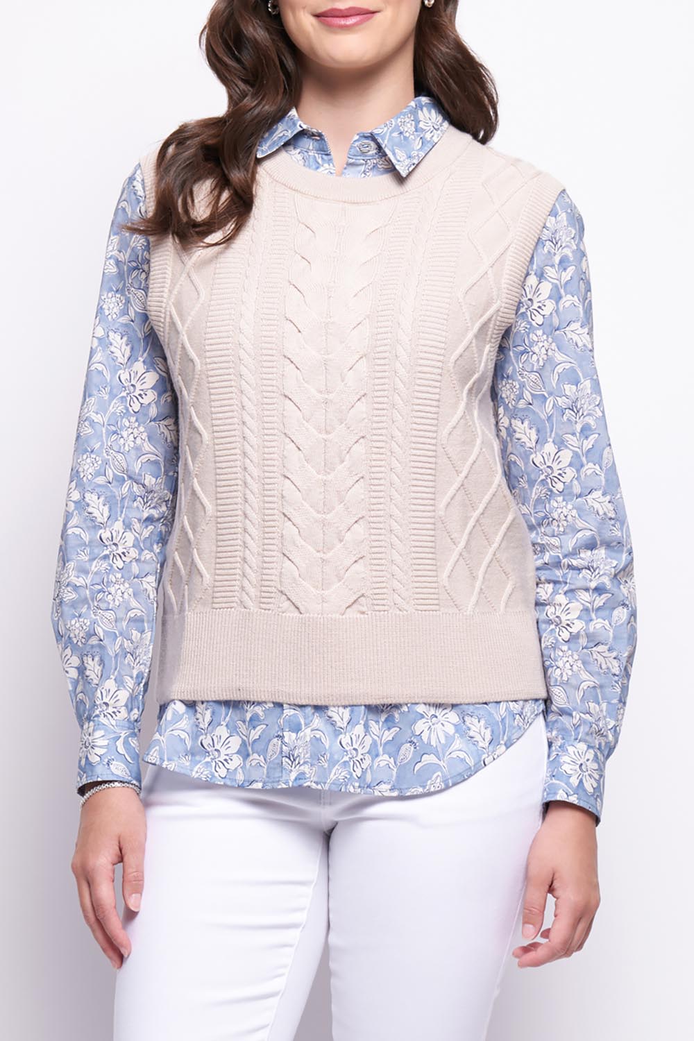 A model wearing the Merino Plot Twist Vest in colour Pearl, from the front, cropped image