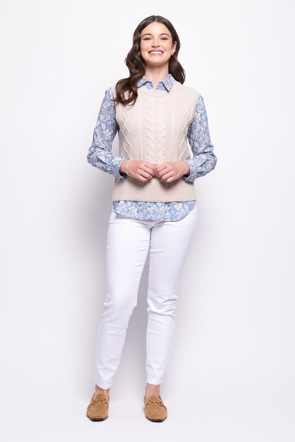 A model wearing the Merino Plot Twist Vest in colour Pearl, from the front, showing the whole outfit