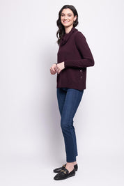 A model wearing the Merino Side By Side Sweater in colour Plum (Purple), from the front, showing the whole outfit