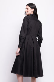 A model wearing the Honourable Mention Cotton Dress in colour Black (Black), from the back