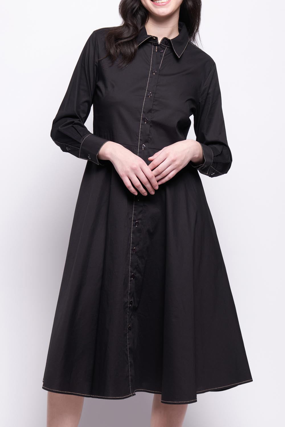 A model wearing the Honourable Mention Cotton Dress in colour Black (Black), from the front, cropped image