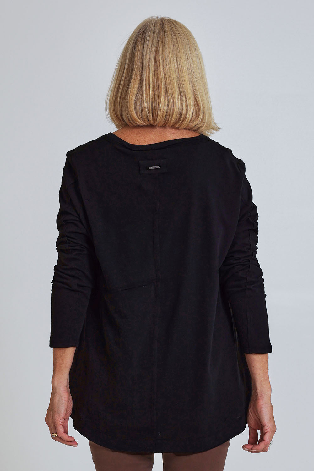 Model Sandy wearing size S of the Deep Connection Cotton Top in colour Black (Black), from the back
