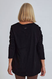 Model Sandy wearing size S of the Deep Connection Cotton Top in colour Black (Black), from the back