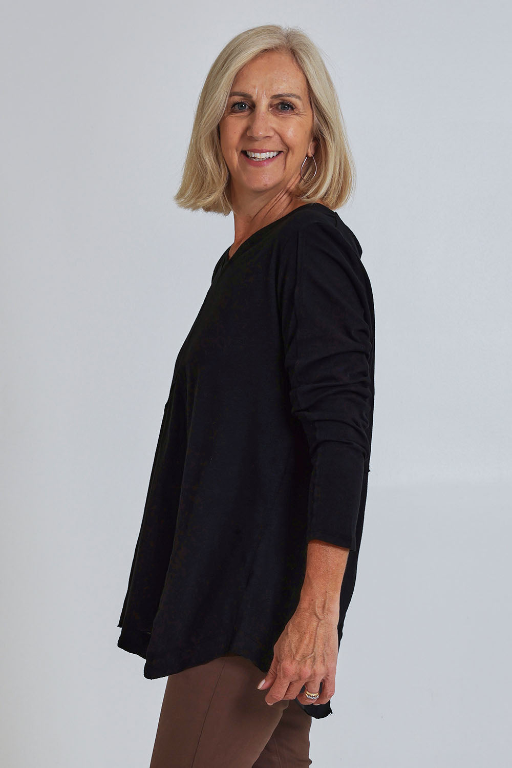 Model Sandy wearing size S of the Deep Connection Cotton Top in colour Black (Black), from the front, cropped image