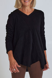 Model Sandy wearing size S of the Deep Connection Cotton Top in colour Black (Black), from the front, cropped image