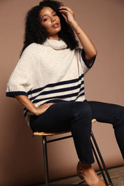 Model Ziara wearing size S of the Plus One Popover in colour Oat, from the front, showing the whole outfit