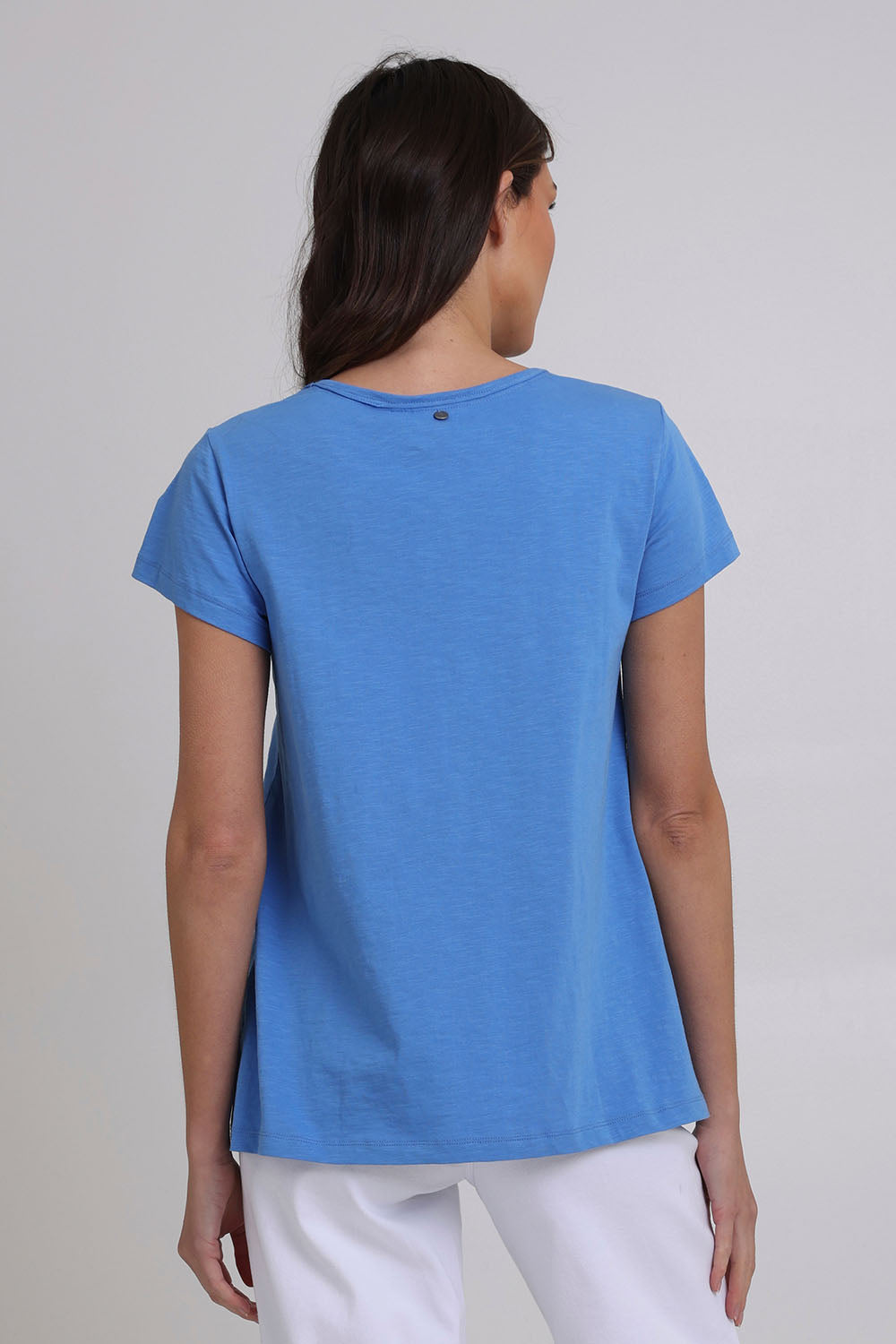 Model Madeline wearing size S of the Frill Factor Cotton Tee in colour Regatta (Blue), from the back