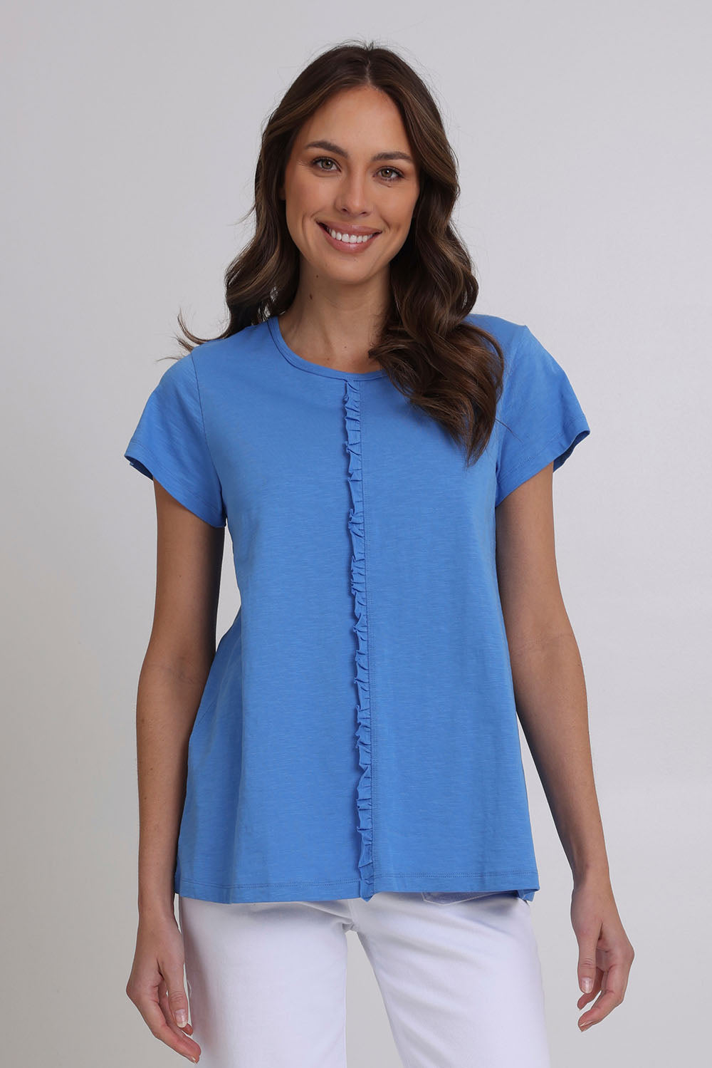 Model Madeline wearing size S of the Frill Factor Cotton Tee in colour Regatta (Blue), from the front, cropped image