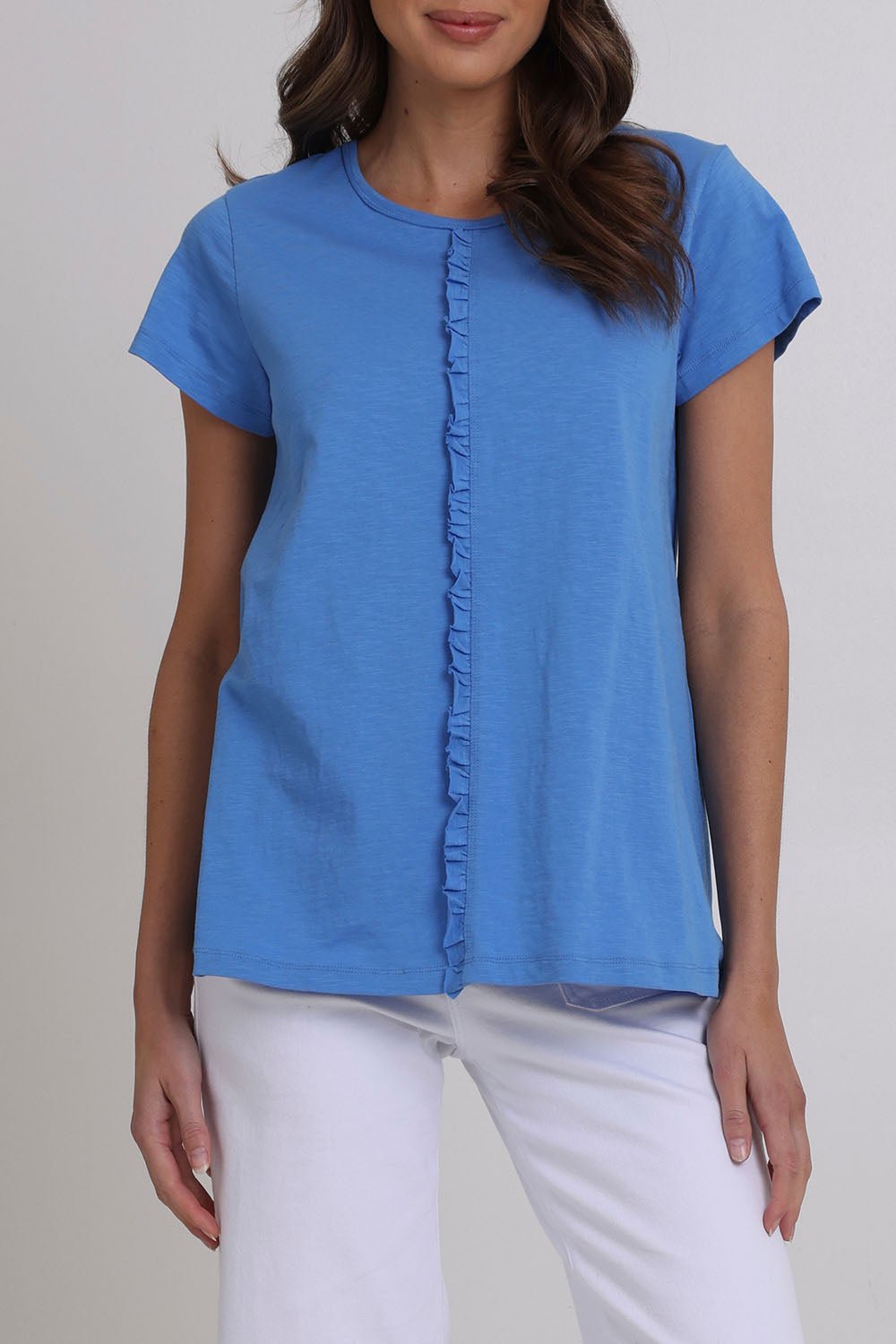 Model Madeline wearing size S of the Frill Factor Cotton Tee in colour Regatta (Blue), from the front, cropped image