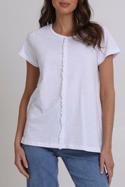 Model Madeline wearing size S of the Frill Factor Cotton Tee in colour White (White), from the front, cropped image