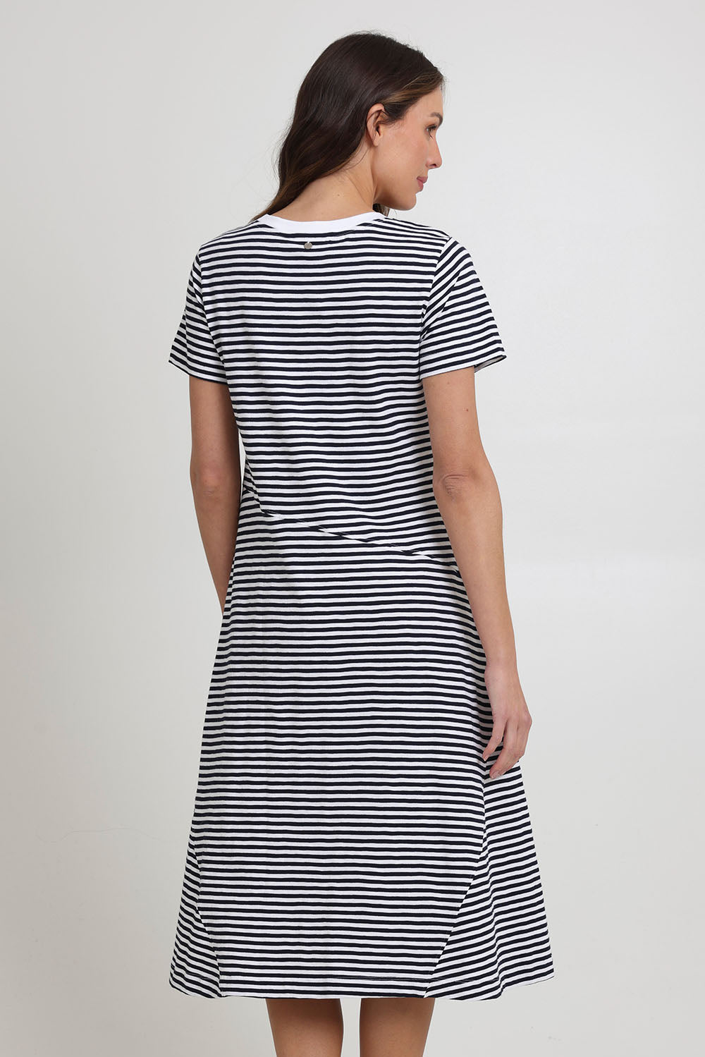 Model Madeline wearing size S of the Stitch Together Cotton Dress in colour Ministripe (Black), from the back