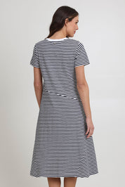 Model Madeline wearing size S of the Stitch Together Cotton Dress in colour Ministripe (Black), from the back