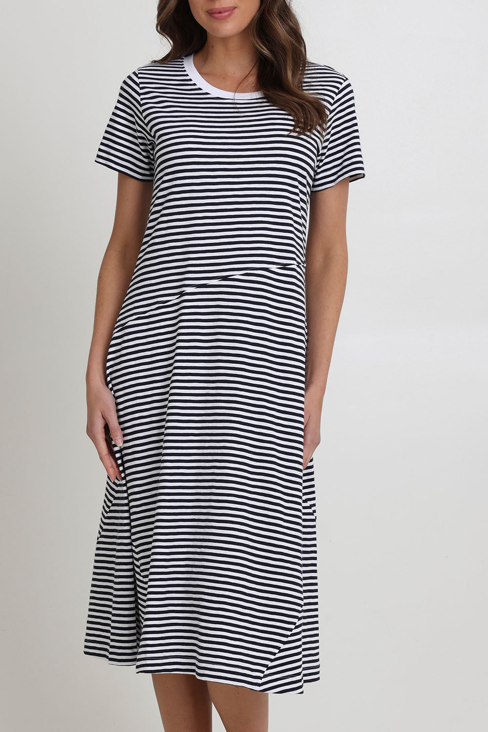 Model Madeline wearing size S of the Stitch Together Cotton Dress in colour Ministripe (Black), from the front, cropped image