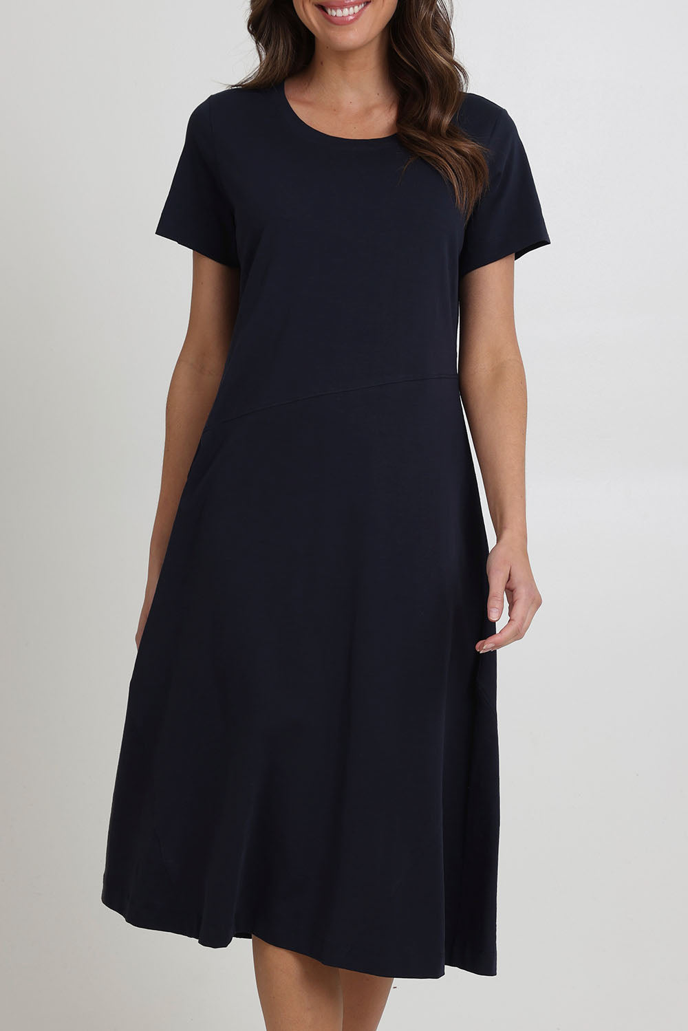Model Madeline wearing size S of the Stitch Together Cotton Dress in colour Truenavy (Blue), from the front, cropped image