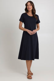 Model Madeline wearing size S of the Stitch Together Cotton Dress in colour Truenavy (Blue), from the front, showing the whole outfit