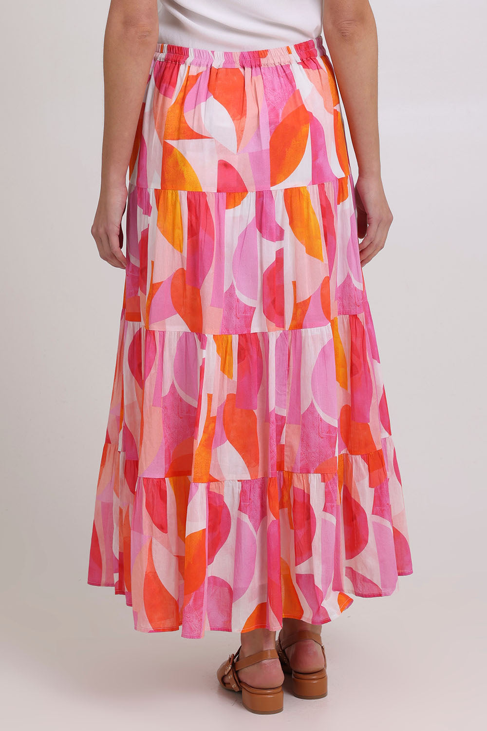 Model Madeline wearing size 10 of the Cruisin Cotton Skirt in colour Peachy (Pink), from the back