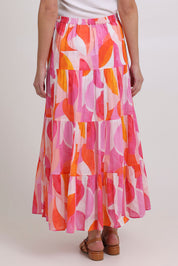 Model Madeline wearing size 10 of the Cruisin Cotton Skirt in colour Peachy (Pink), from the back