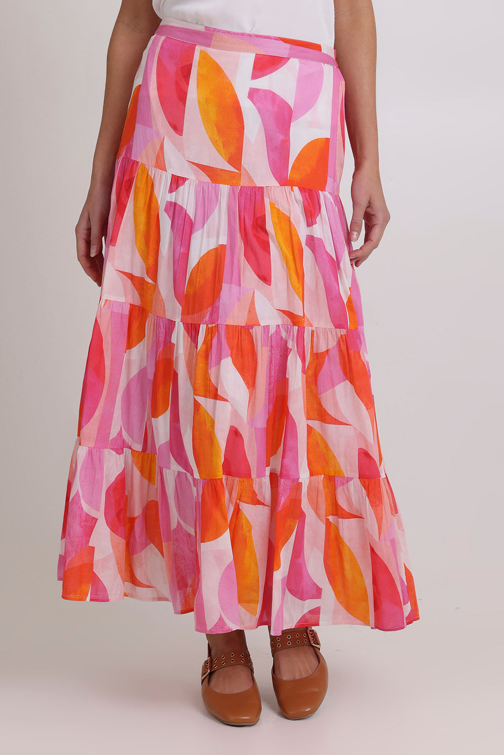 Model Madeline wearing size 10 of the Cruisin Cotton Skirt in colour Peachy (Pink), from the front, cropped image