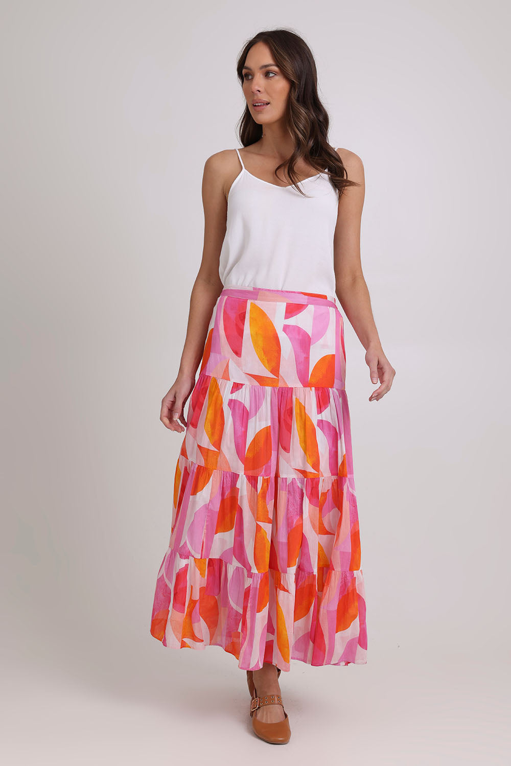 Model Madeline wearing size 10 of the Cruisin Cotton Skirt in colour Peachy (Pink), from the front, showing the whole outfit