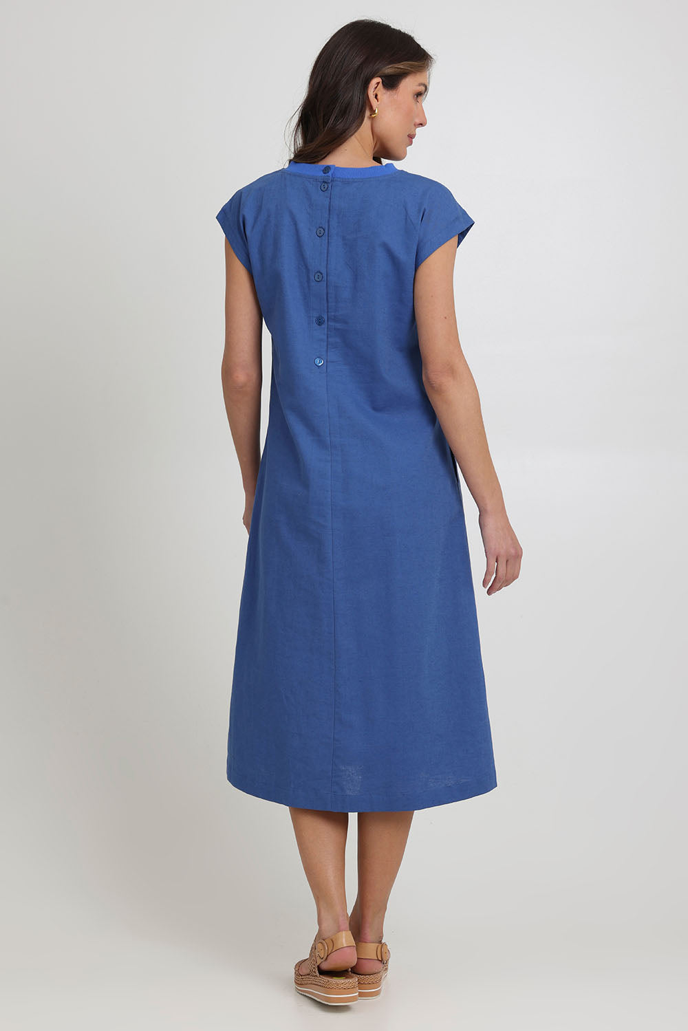 Model Madeline wearing size 10 of the Cut Of Your Rib Dress in colour Savoyblue (Blue), from the back