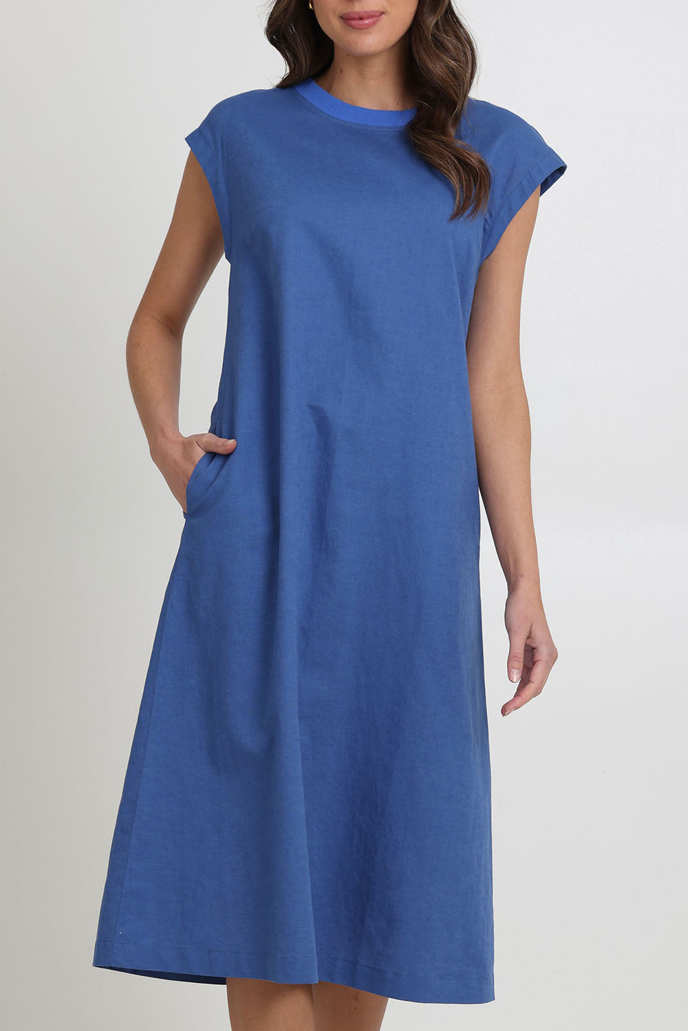 Model Madeline wearing size 10 of the Cut Of Your Rib Dress in colour Savoyblue (Blue), from the front, cropped image