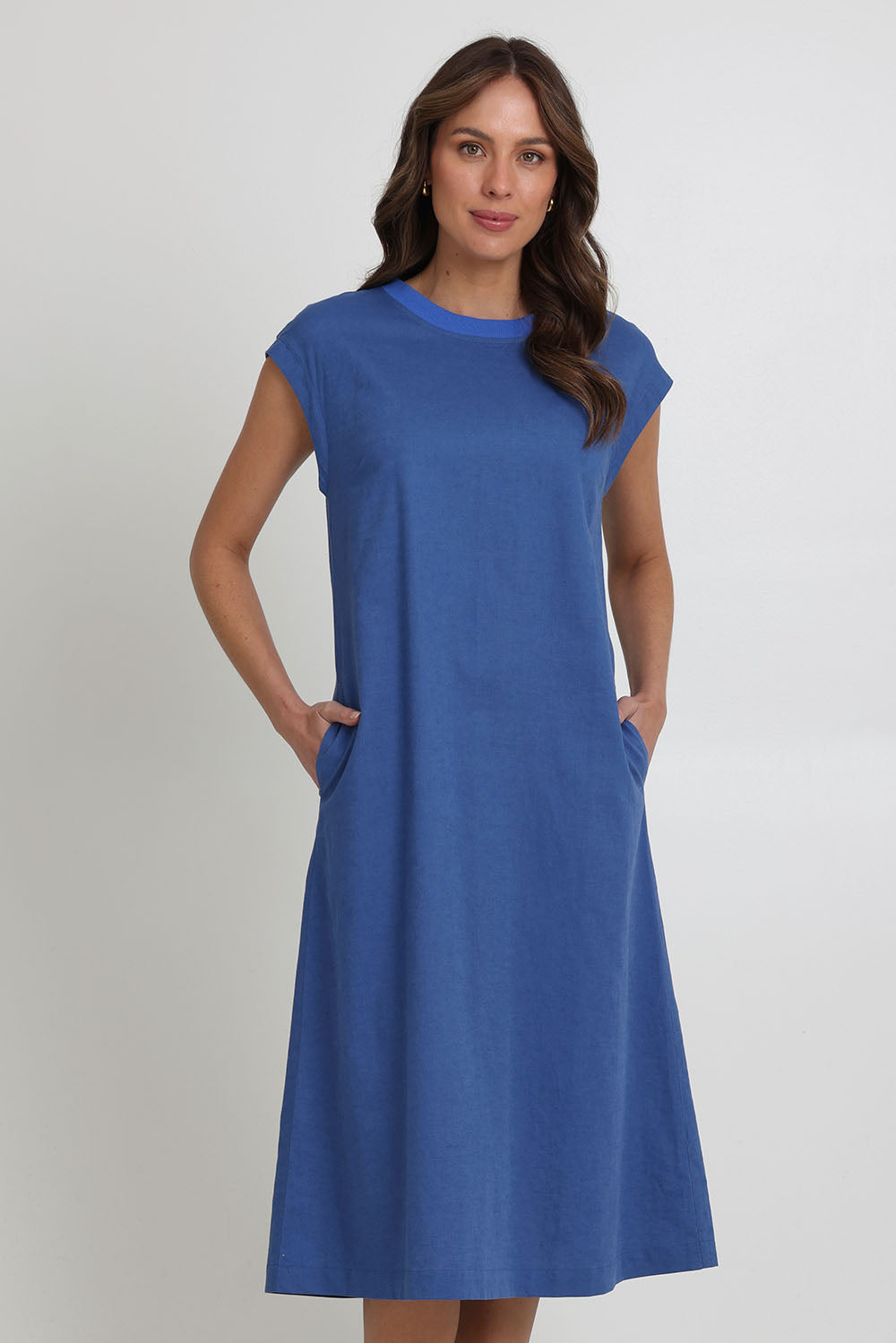 Model Madeline wearing size 10 of the Cut Of Your Rib Dress in colour Savoyblue (Blue), from the front, cropped image