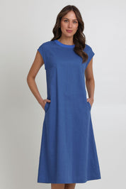 Model Madeline wearing size 10 of the Cut Of Your Rib Dress in colour Savoyblue (Blue), from the front, cropped image