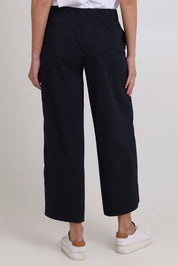 Model Madeline wearing size 10 of the Broad Horizons Cotton Blend Pant in colour Truenavy (Blue), from the back