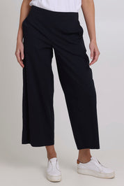 Model Madeline wearing size 10 of the Broad Horizons Cotton Blend Pant in colour Truenavy (Blue), from the front, cropped image