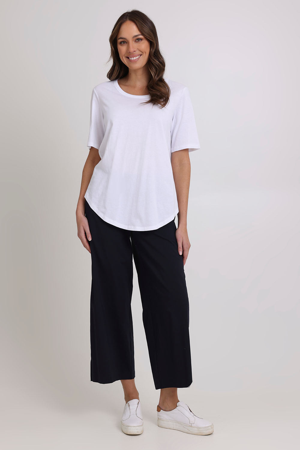 Model Madeline wearing size 10 of the Broad Horizons Cotton Blend Pant in colour Truenavy (Blue), from the front, showing the whole outfit