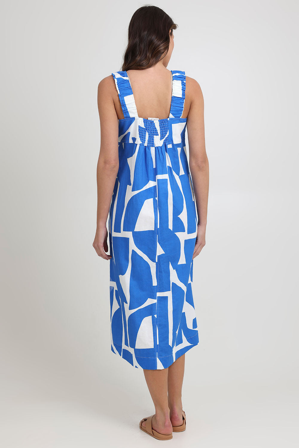 Model Madeline wearing size 10 of the Sunseeker Linen Cotton Dress in colour Reflection (Blue), from the back