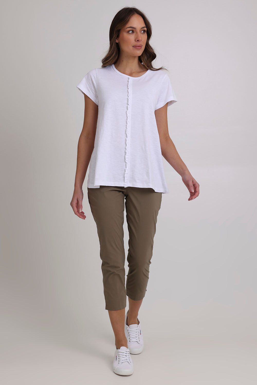 Model Madeline wearing size 10 of the Fuss Free 7/8 Pant in colour Dune (Green), from the front, showing the whole outfit