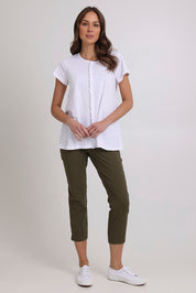Model Madeline wearing size 10 of the Fuss Free 7/8 Pant in colour Kelp (Green), from the front, showing the whole outfit