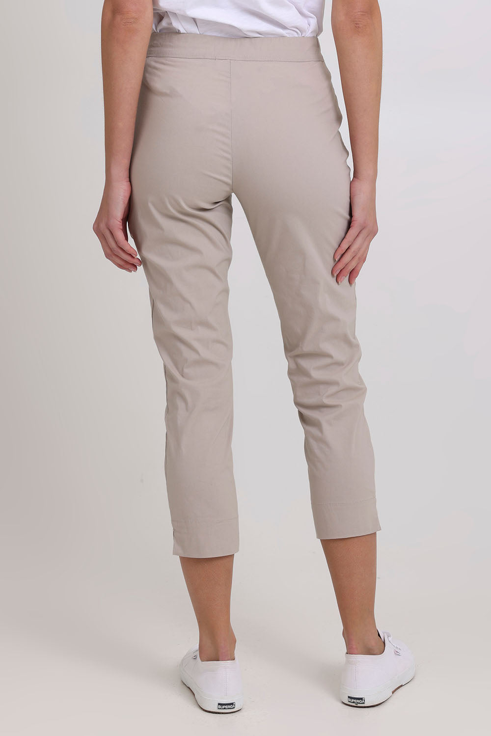 Model Madeline wearing size 10 of the Fuss Free 7/8 Pant in colour Sand, from the back